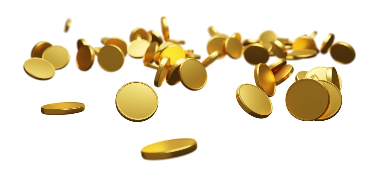 A gold coin falling against a white background